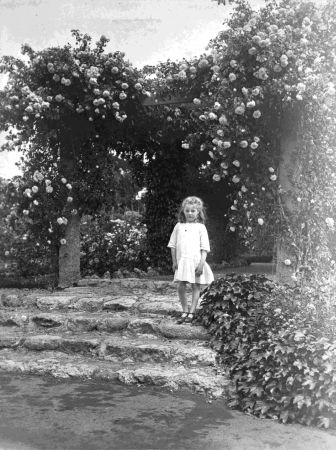 Laurel standing at an entrance to the pergola, Greenhill homestead near Hastings